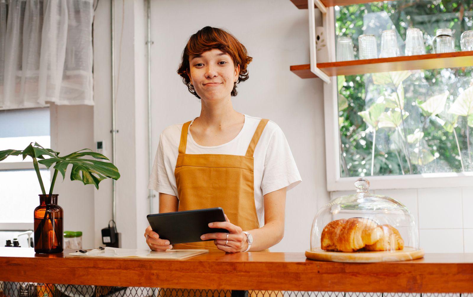 Sales associate taking a special order on a
                    tablet at the bakery counter